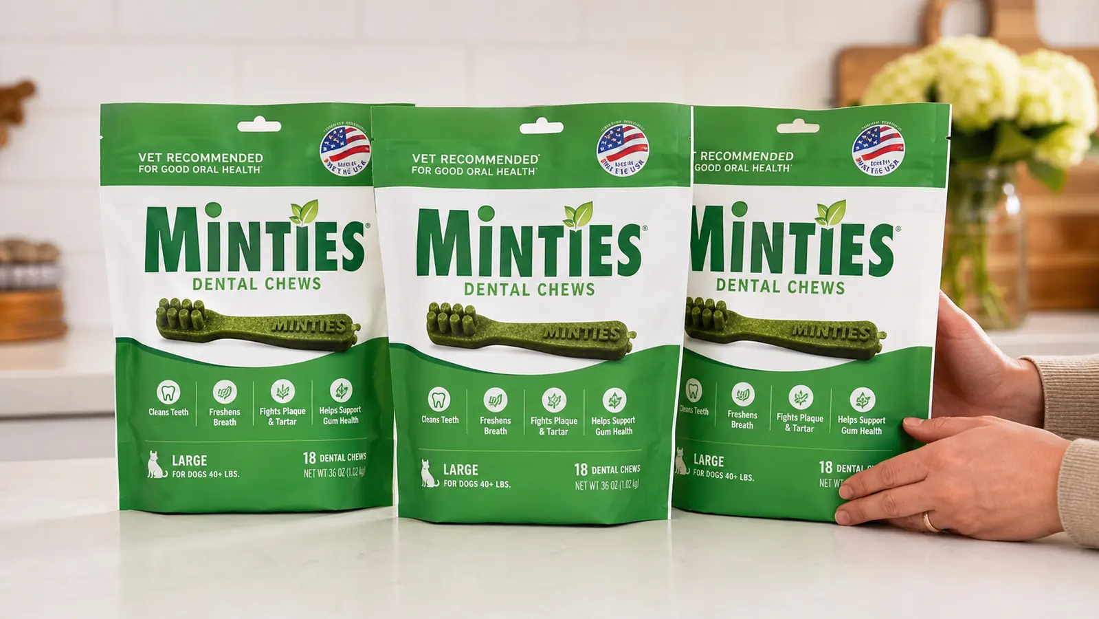 Three Minties dental chew bags showing small, medium, and large size packaging side by side