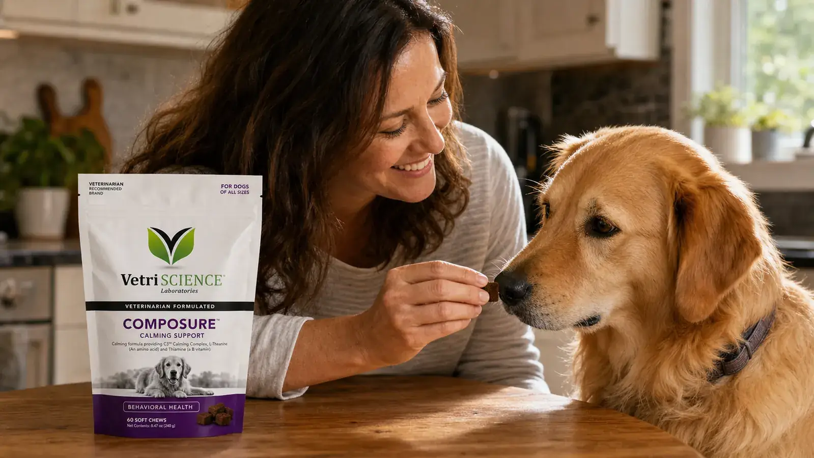 Hand holding a VetriScience Composure calming chew near a dog's mouth